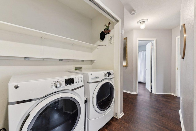 laundry area with laundry area, baseboards, separate washer and dryer, and dark wood finished floors