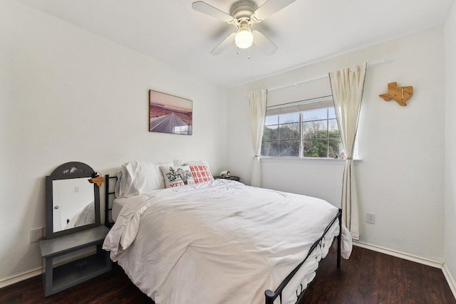 bedroom with wood finished floors, a ceiling fan, and baseboards