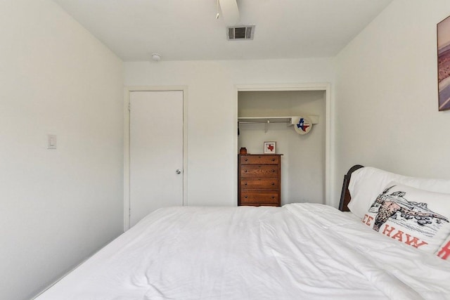 bedroom featuring ceiling fan, a closet, and visible vents