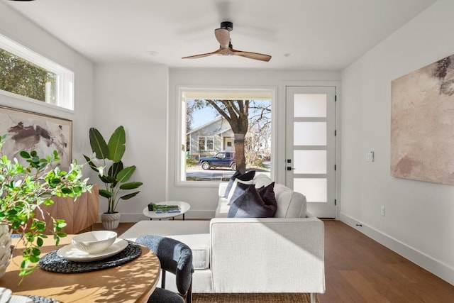 dining room featuring baseboards, wood finished floors, and a ceiling fan