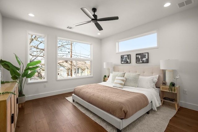 bedroom with recessed lighting, wood finished floors, visible vents, and baseboards