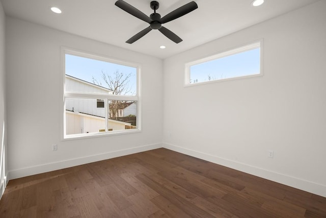 spare room with recessed lighting, baseboards, and dark wood-style flooring