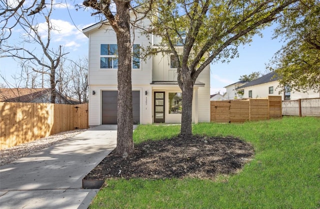 modern home featuring an attached garage, fence, board and batten siding, and driveway