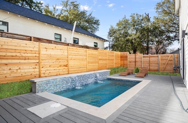 view of pool with a fenced in pool, a wooden deck, and a fenced backyard