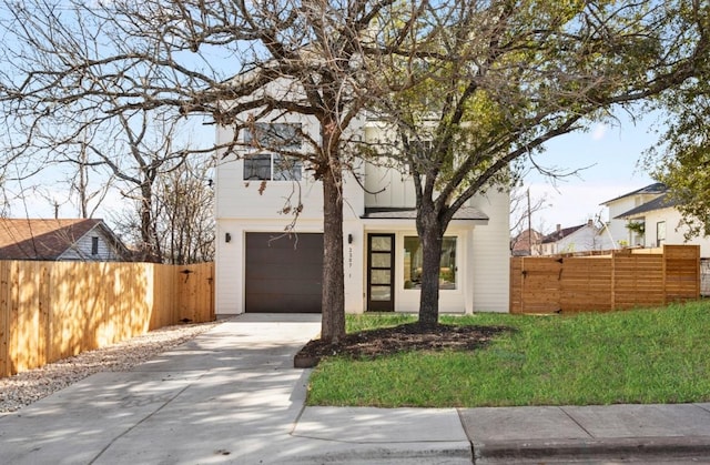 view of front of home featuring concrete driveway and fence