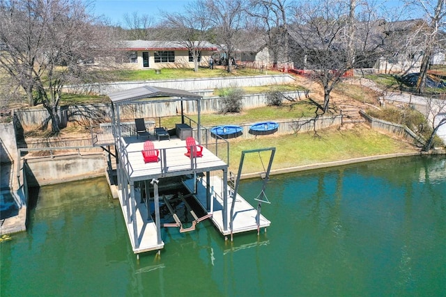 dock area with an outdoor fire pit, a water view, a yard, fence, and a gazebo