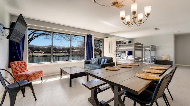 dining room featuring an inviting chandelier, baseboards, and visible vents