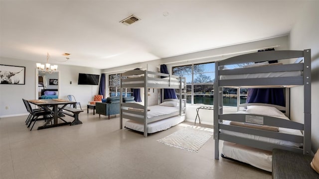 bedroom with baseboards, visible vents, and an inviting chandelier