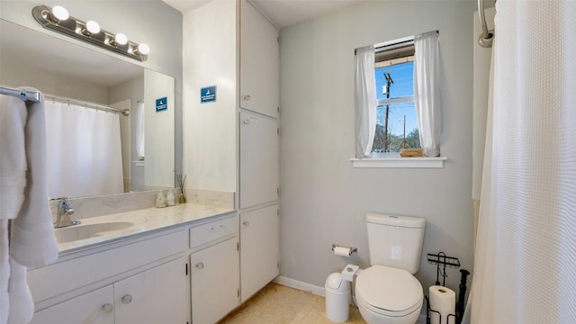 bathroom with baseboards, toilet, curtained shower, tile patterned flooring, and vanity