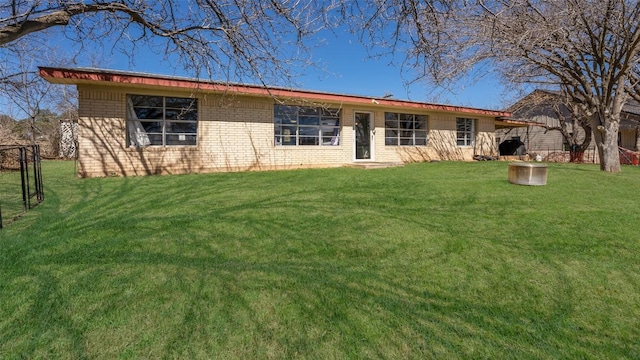 single story home featuring brick siding and a front lawn