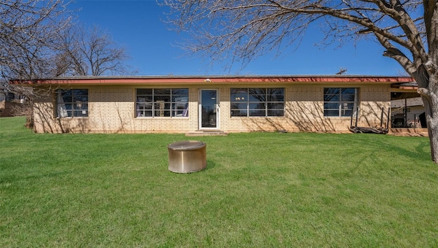 ranch-style home with a front lawn and brick siding