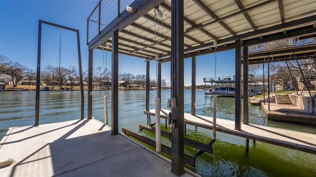 dock area with a water view and boat lift