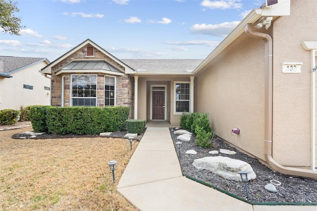 entrance to property with stucco siding and stone siding