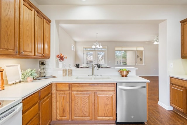 kitchen with a peninsula, a sink, light countertops, dark wood-type flooring, and stainless steel dishwasher