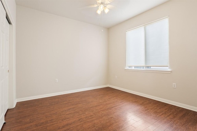 unfurnished bedroom with ceiling fan, wood finished floors, a closet, and baseboards