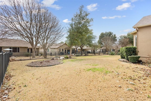 view of yard featuring fence and a residential view