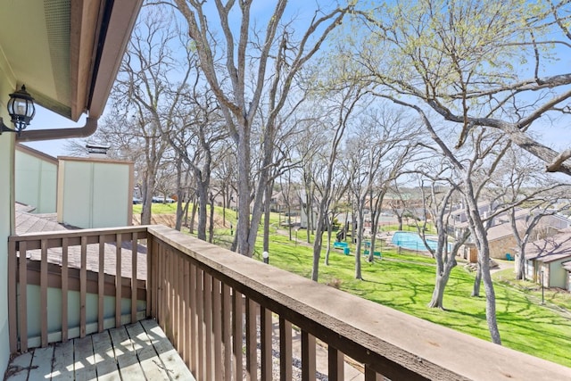 wooden terrace featuring a lawn