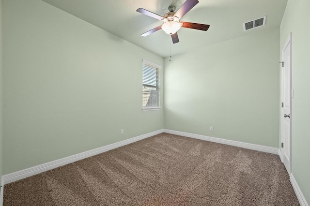 spare room featuring a ceiling fan, carpet, visible vents, and baseboards