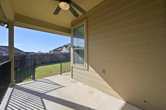 view of patio / terrace with fence and a ceiling fan