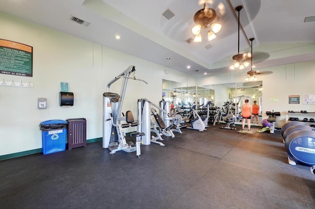 exercise room with lofted ceiling, ceiling fan, visible vents, and baseboards