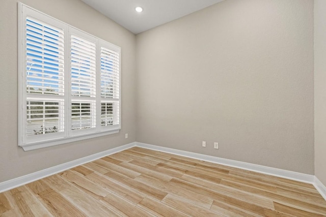 unfurnished room featuring light wood-style floors and baseboards