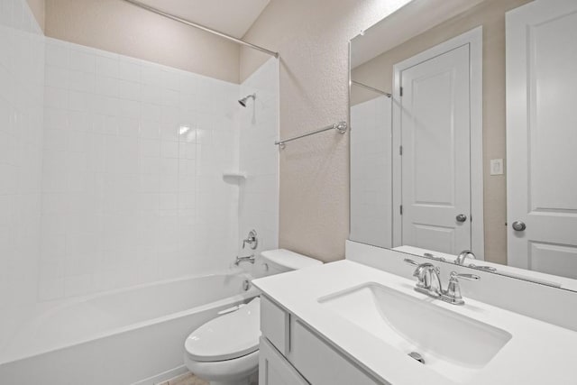 full bathroom featuring toilet, a textured wall, vanity, and bathing tub / shower combination