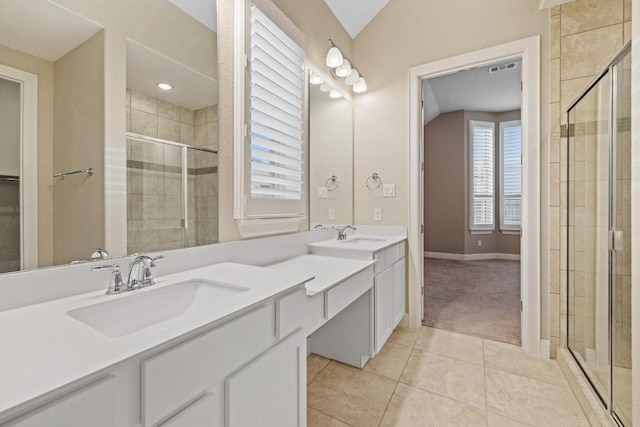 full bathroom with a sink, vaulted ceiling, a shower stall, tile patterned floors, and double vanity