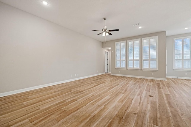 spare room with light wood finished floors, recessed lighting, visible vents, ceiling fan, and baseboards