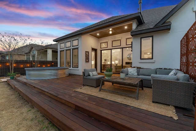 wooden deck with a covered hot tub, an outdoor living space, and fence