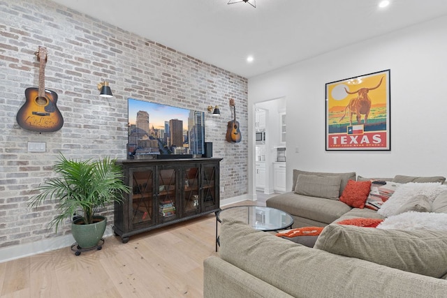 living room with recessed lighting, brick wall, and wood finished floors