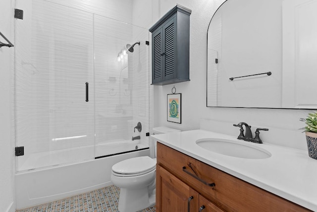 full bath featuring combined bath / shower with glass door, toilet, and vanity