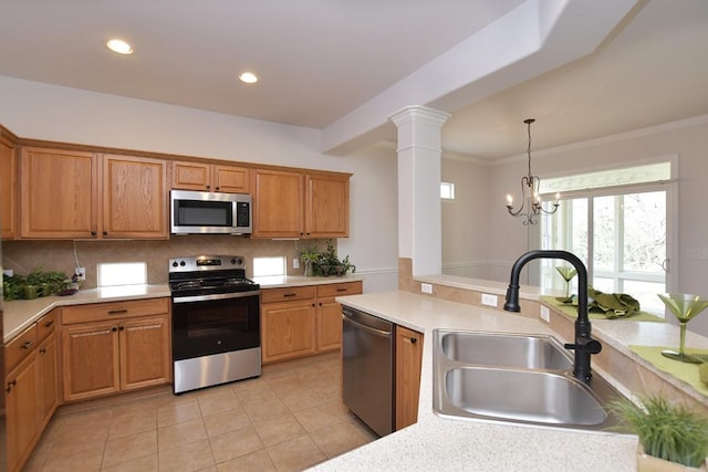 kitchen featuring stainless steel appliances, backsplash, a sink, and light countertops