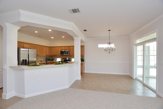 kitchen with appliances with stainless steel finishes, visible vents, decorative columns, and light carpet