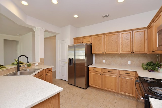 kitchen featuring light countertops, visible vents, backsplash, a sink, and stainless steel fridge with ice dispenser