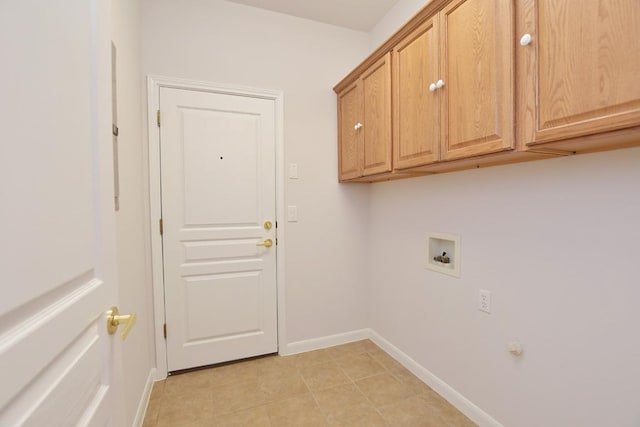 clothes washing area with cabinet space, hookup for a washing machine, and baseboards