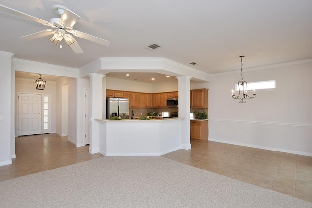 kitchen featuring appliances with stainless steel finishes, light colored carpet, visible vents, and brown cabinets