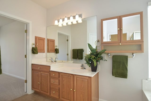 full bath with double vanity, a sink, and tile patterned floors