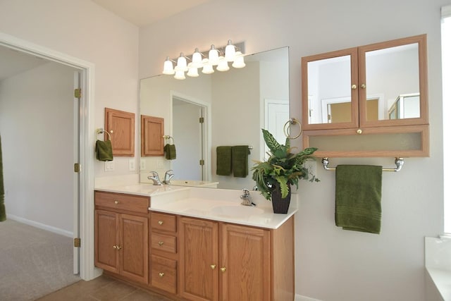 715 Texas Dr, Georgetown, TX 78633 - bathroom with double vanity, baseboards, and tile patterned floors