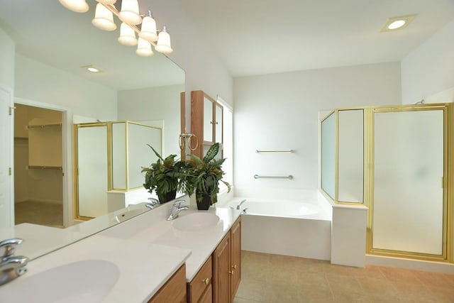 bathroom featuring a bath, a shower stall, and a sink