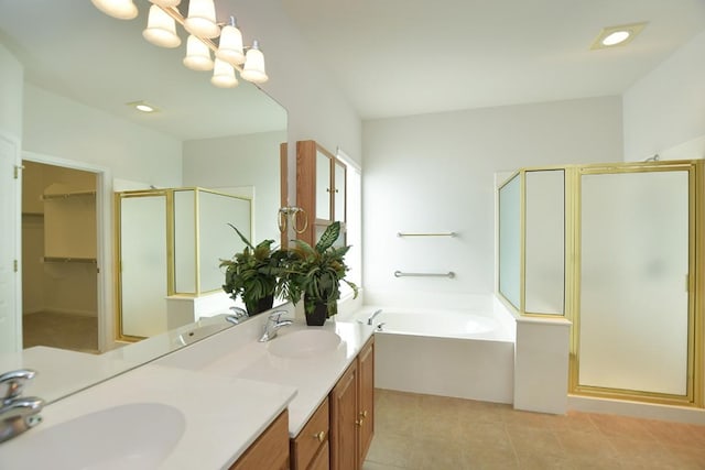 715 Texas Dr, Georgetown, TX 78633 - full bath featuring a stall shower, a bath, double vanity, a walk in closet, and tile patterned floors