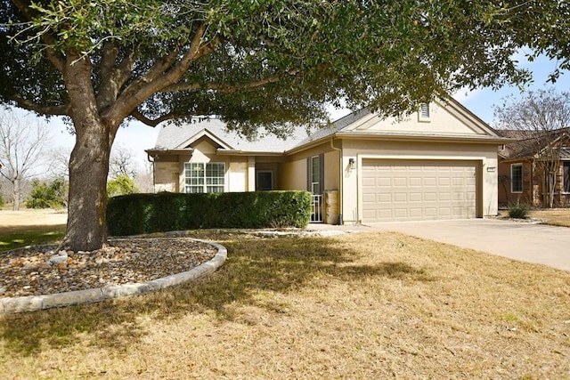 ranch-style home with an attached garage, concrete driveway, and stucco siding