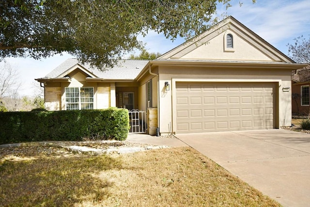 ranch-style home with driveway, an attached garage, and stucco siding