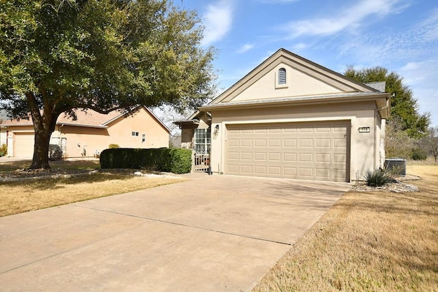 single story home with a garage, concrete driveway, central AC unit, and stucco siding