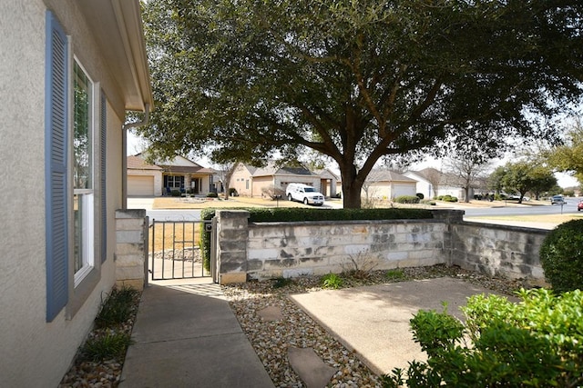 view of patio with a gate and a residential view