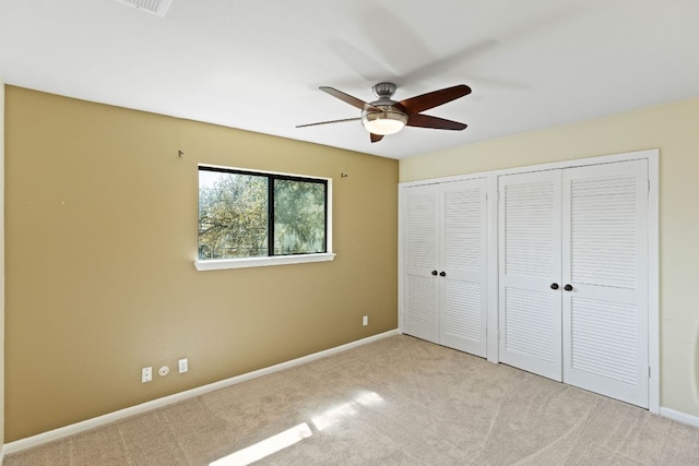 7701 Penelope Cir, Austin, TX 78759 - unfurnished bedroom with carpet, two closets, a ceiling fan, and baseboards