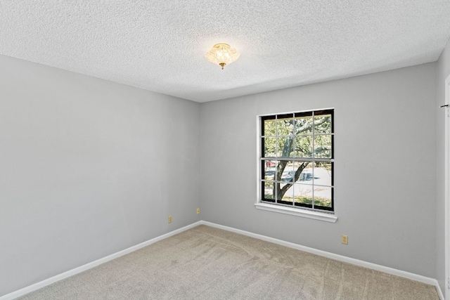 7701 Penelope Cir, Austin, TX 78759 - carpeted spare room with baseboards and a textured ceiling