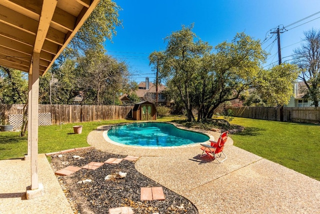 7701 Penelope Cir, Austin, TX 78759 - view of swimming pool with a fenced in pool, a patio, a fenced backyard, an outbuilding, and a yard