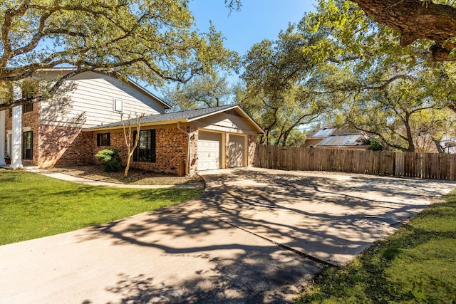 7701 Penelope Cir, Austin, TX 78759 - view of front of property featuring brick siding, concrete driveway, an attached garage, fence, and a front yard
