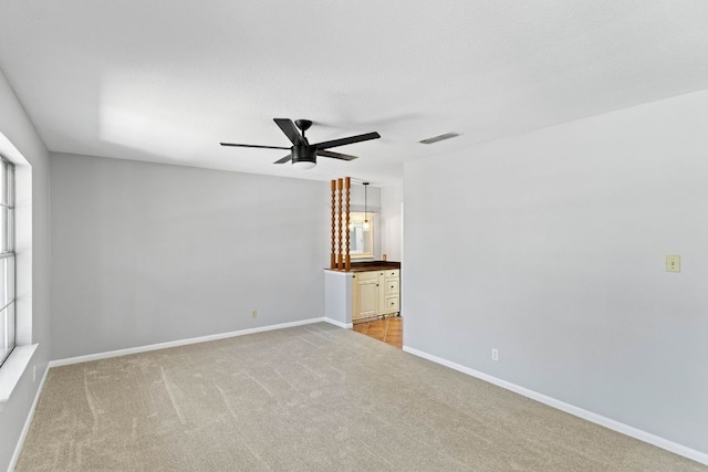 7701 Penelope Cir, Austin, TX 78759 - empty room with a ceiling fan, light carpet, visible vents, and baseboards