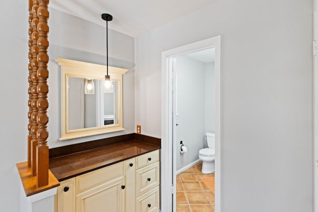7701 Penelope Cir, Austin, TX 78759 - bathroom featuring vanity, tile patterned flooring, toilet, and baseboards